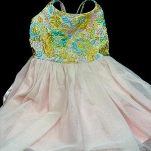 Formal pink dress with a shimmery floral detail.